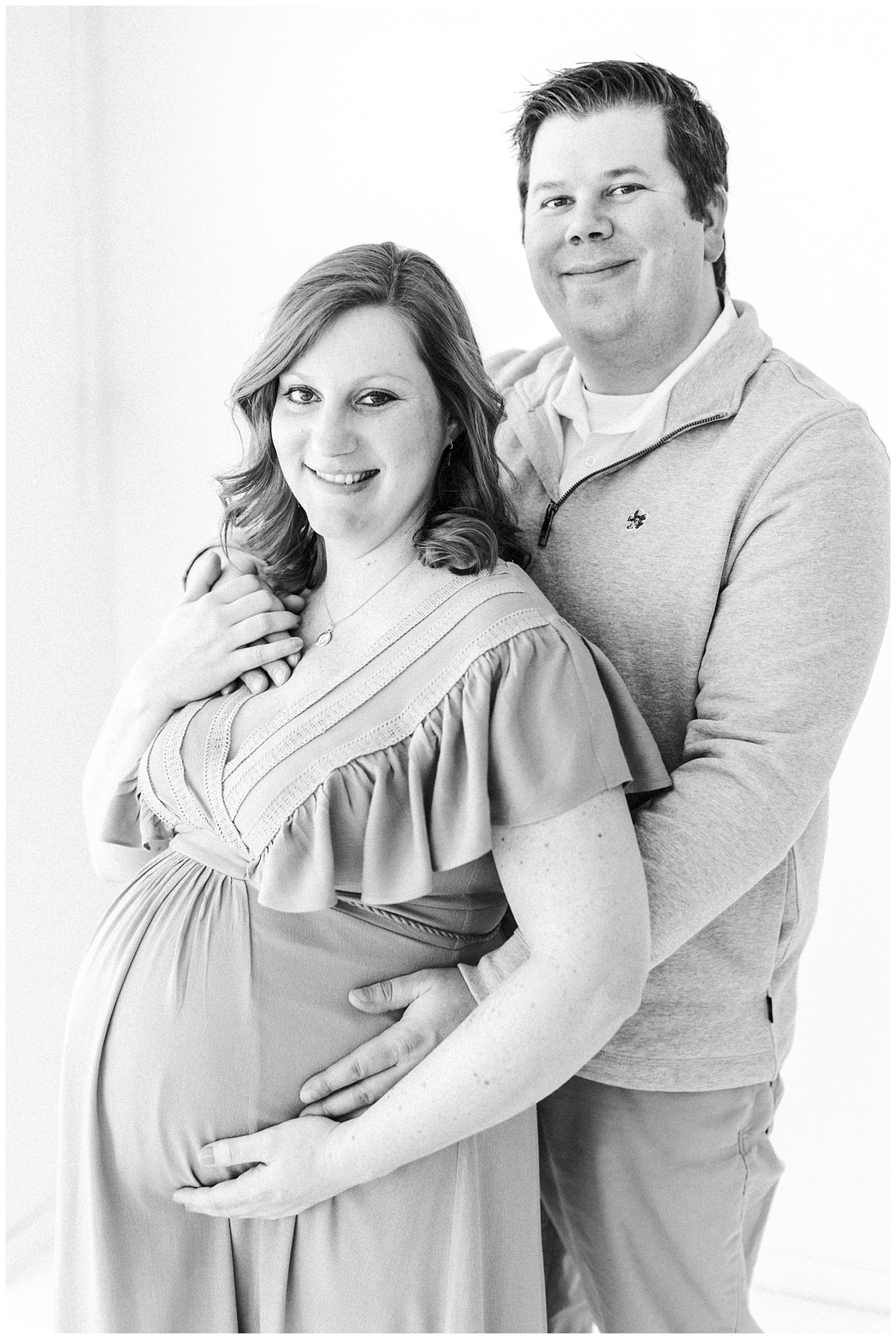 man and woman posed maternity photo